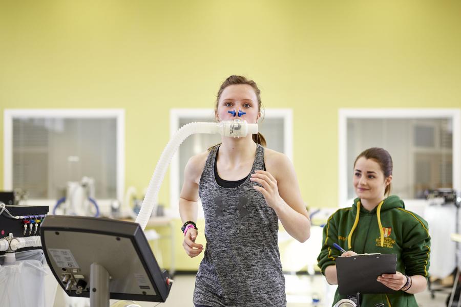 Students measuring oxygen consumption during exercise using a Douglas bag