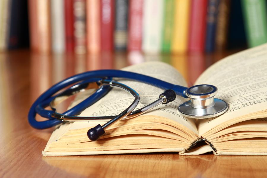 A stethoscope lying on an open book
