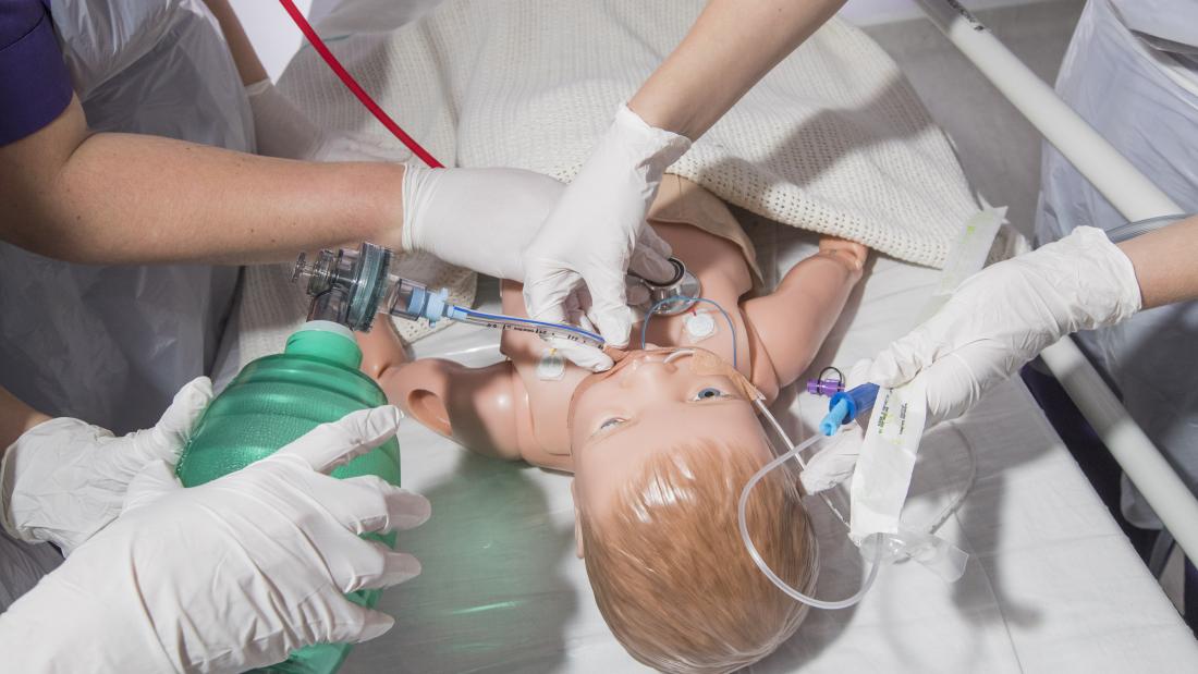 Midwifery students training on a dummy