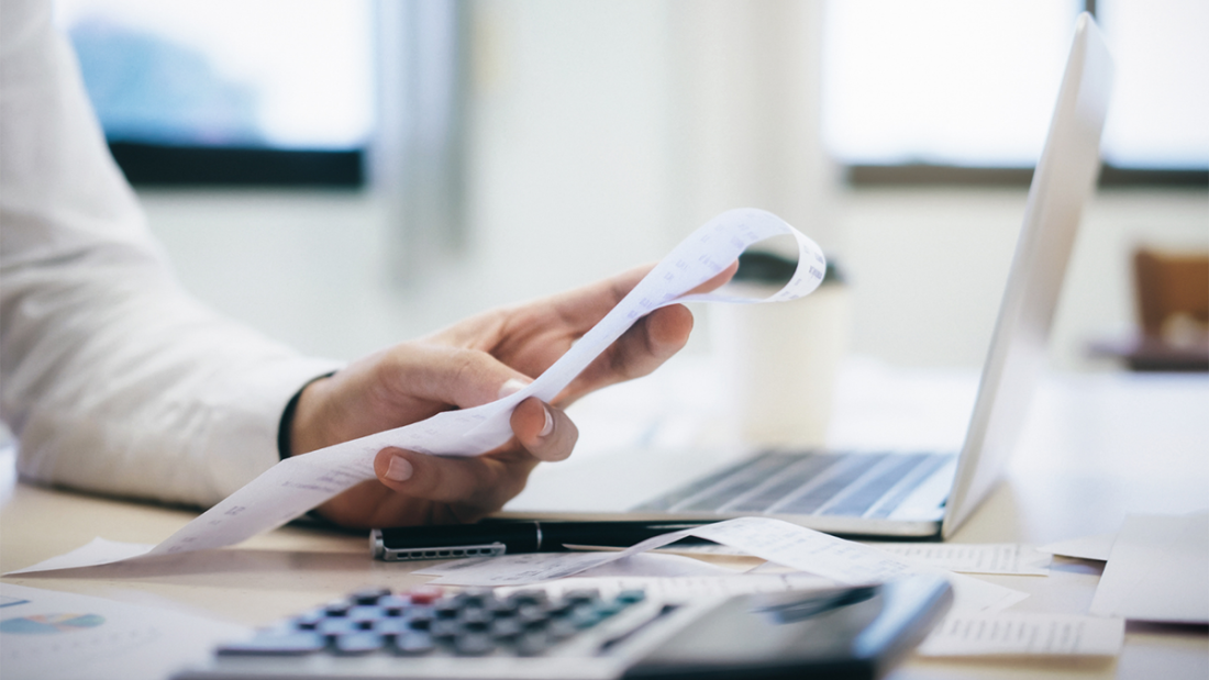 Calculator and laptop on desk