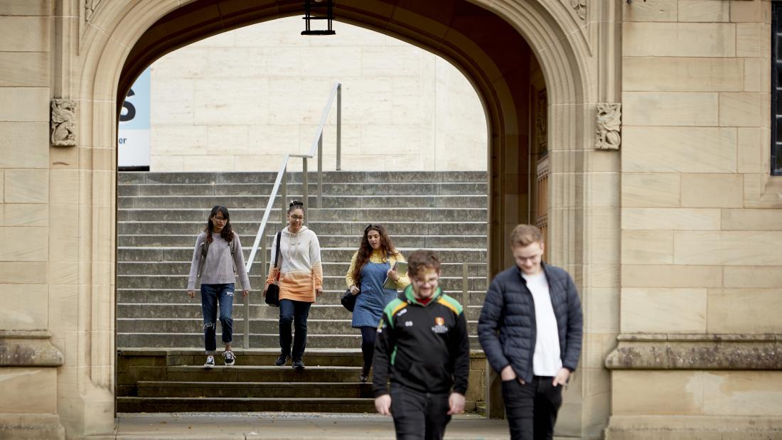 Students walking from Pontio through Memorial Arch