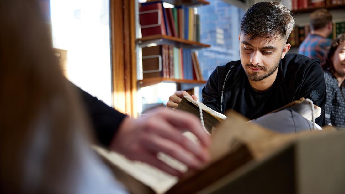 A student looking through the archives at the University