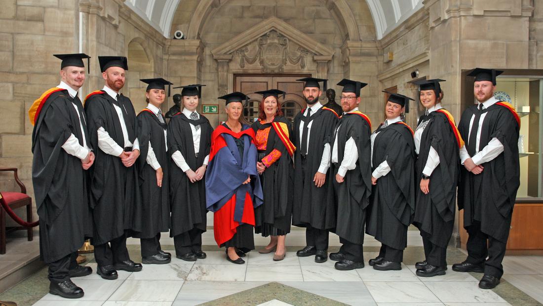 A group of graduates with lecturers