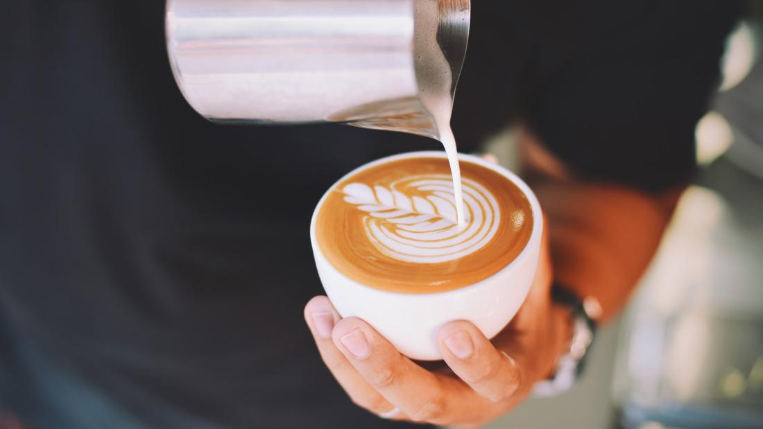 Close-up of Hand Holding Cappuccino