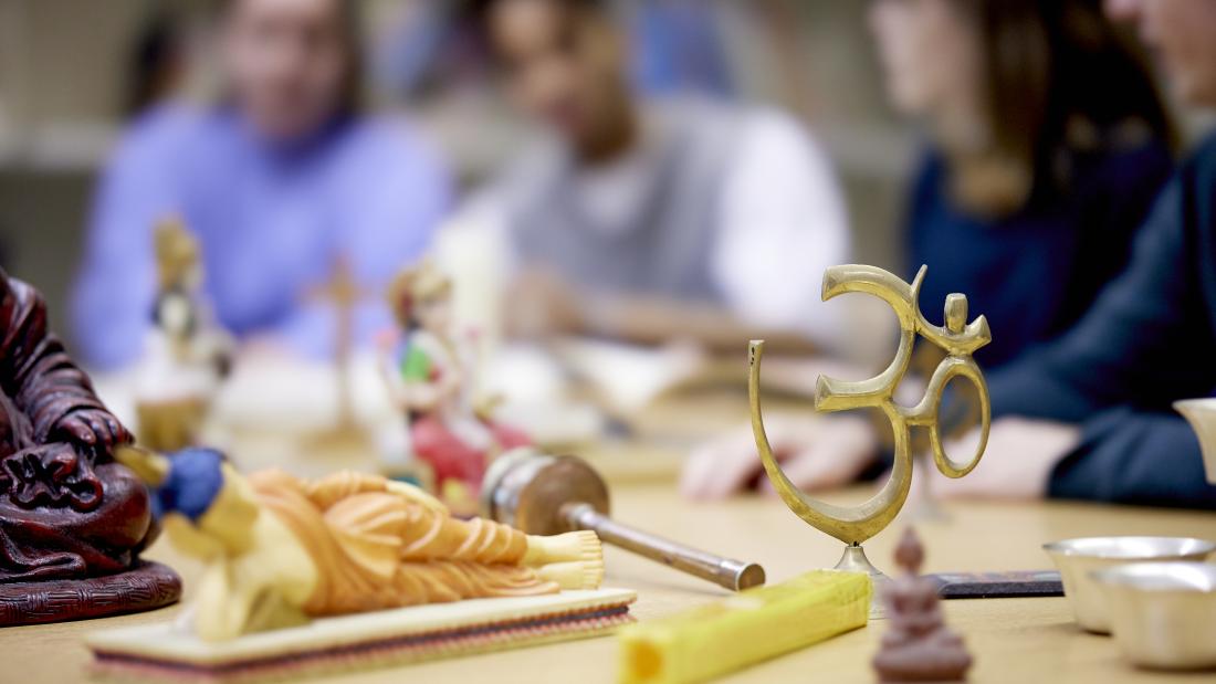 Religious models on table with students looking at them 
