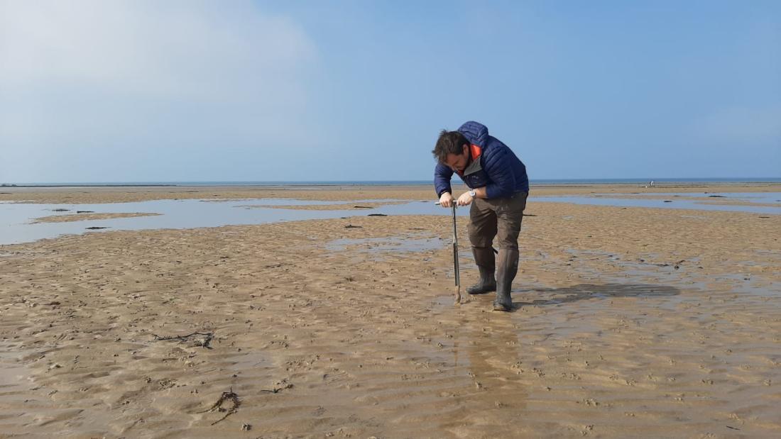 Professor Christian Dunn taking samples on a beach