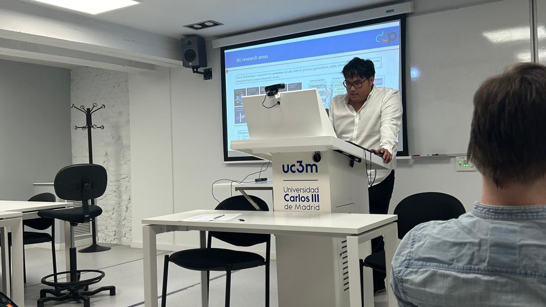 Postdoctoral researcher delivering guest lecture at Madrid University
