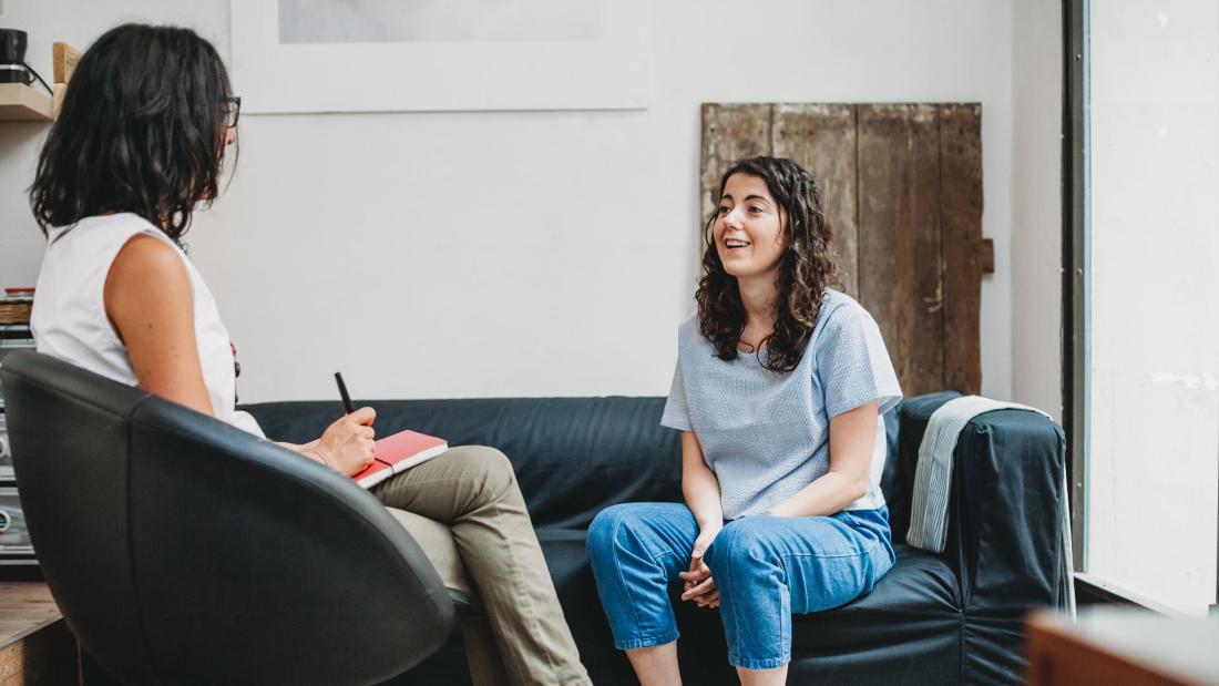 Psychologist during therapy session with young girl