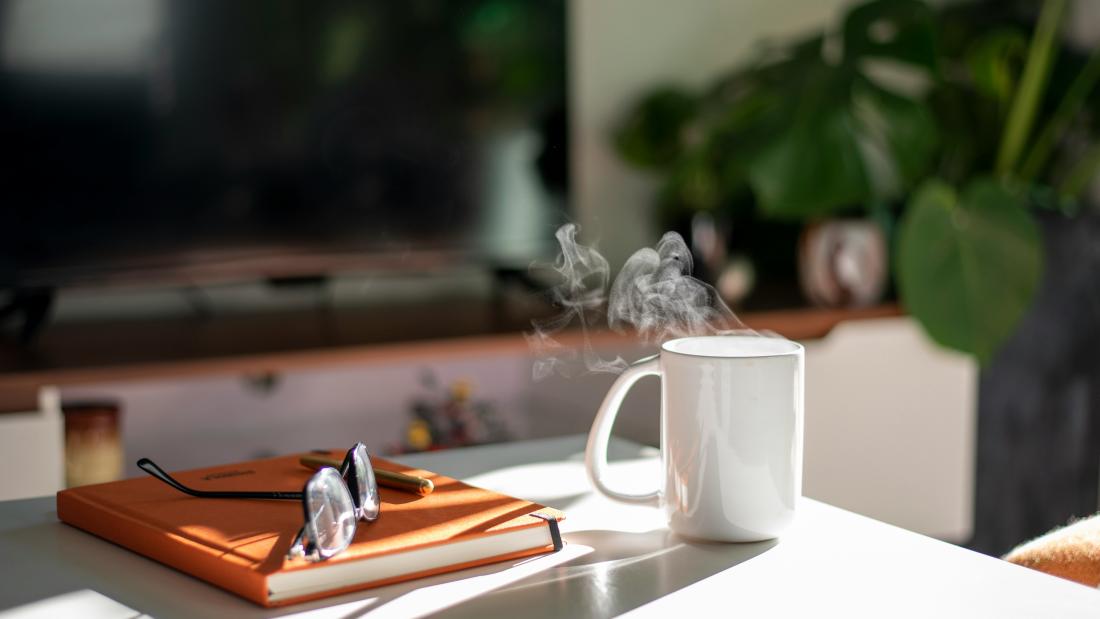 Image of a cup and book on a table