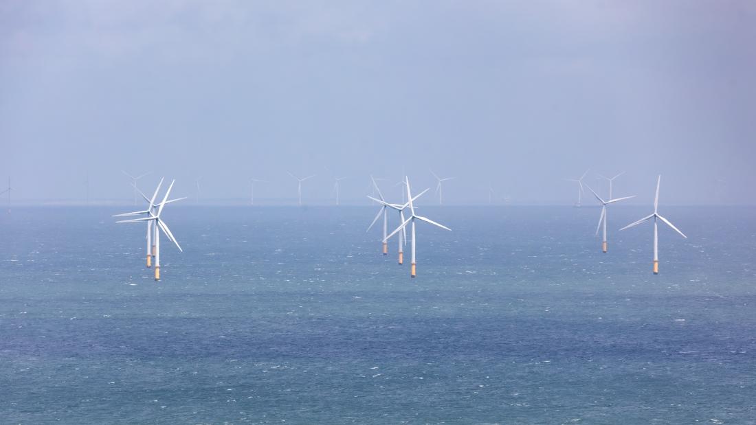 ind farm turbines providing alternative energy in open ocean water. Gwynt y Môr Off the coast of Llandudno, North Wales. United Kingdom