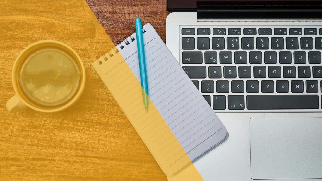 Image of coffee cup notebook and laptop on a table