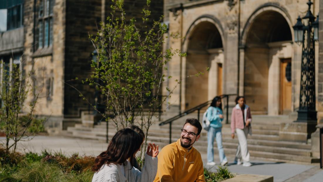 Image of students in front of the main arts building