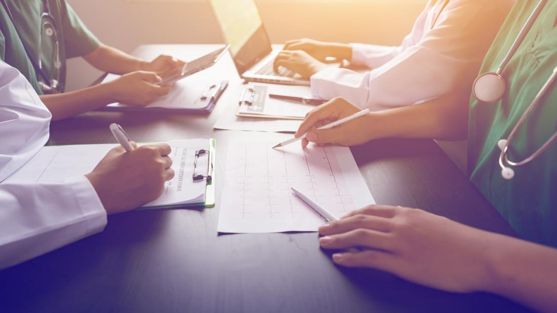 Image of a group of clinicians working around a table