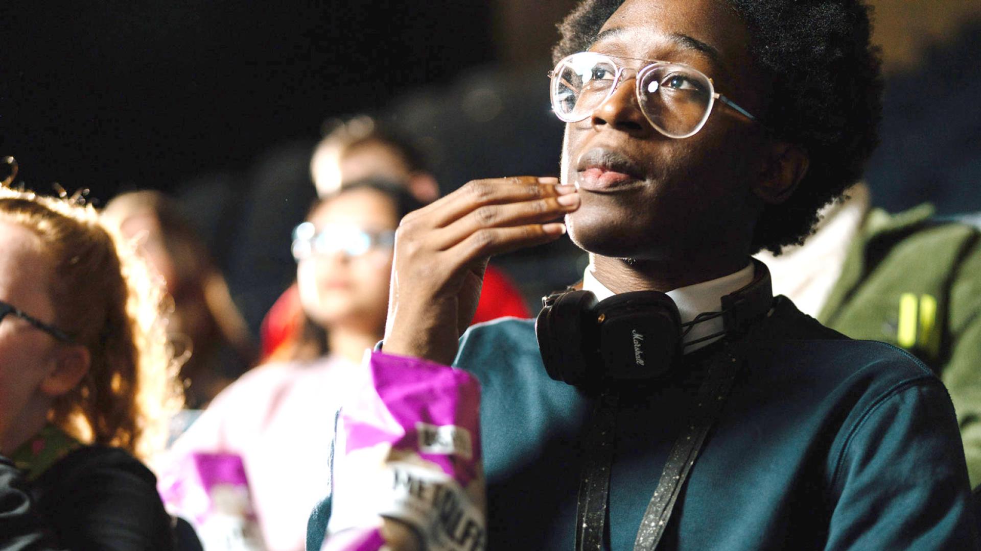 Students watching a film in movie theatre