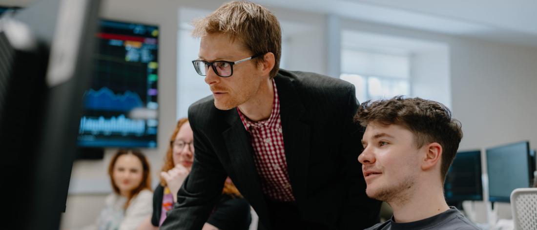 lecturer teaching students in computer lab