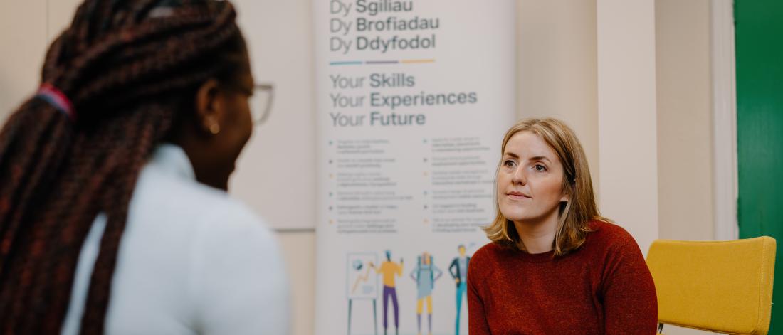 Student sat talking to employability advisor