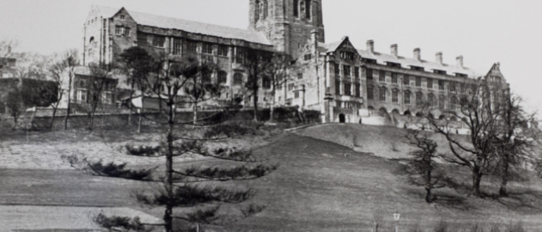 Black and white photograph of Bangor University Main Arts Building at the top of a hill