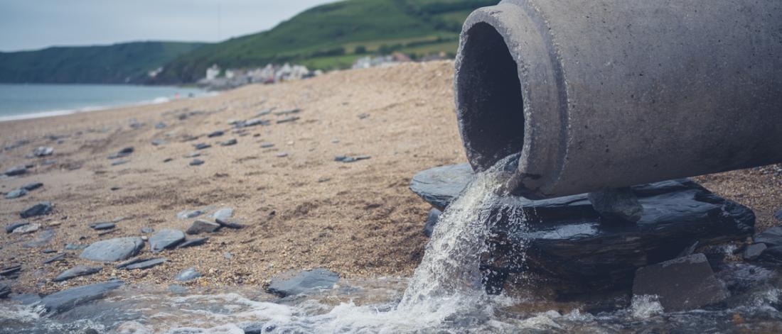 A large sewage pipe on the beach