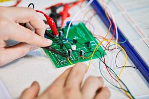 A student using a circuit board in a lab 