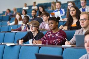 Students taking notes in a lecture theatre