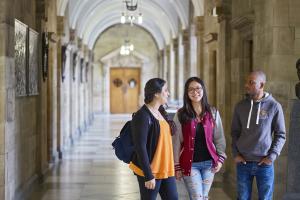 Students walking through a corridor at the Main Arts Building