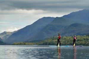 Students paddle boarding on a lake 