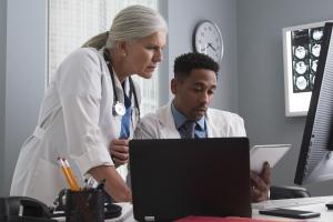 Clinical medical setting. People looking at scans.