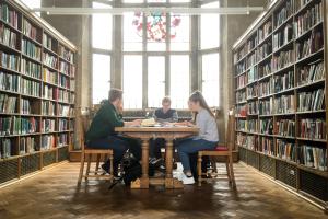 Students reading and working together in one of the libraries traditional reading rooms, on the Main Arts campus