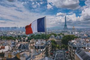 French flag flying in Paris with Eiffel Tower in the background