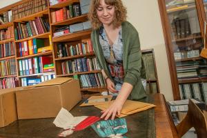 a volunteer looking at various archival documents