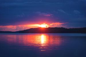 a landscape image of the sea,mountain and a sunset 