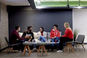 Students sitting together having a drink and socialising in Bar Uno, Ffriddoedd Village