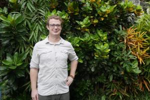 Image of Edwin Pynegar standing in front of greenery