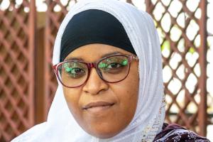 Member of Dahari staff, Raissa Bakari, with trellis in the background