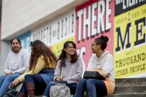 Students chatting on the steps outside Pontio