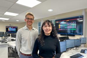 Two people standing on a Trading Room floor
