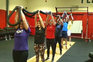 a group lifting a rope over their heads