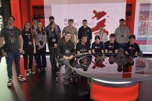 Students sitting at the news desk of BBC Wales Cardiff