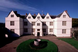 Photograph of St Fagans Castle, a symmetrical mansion, rendered and painted white