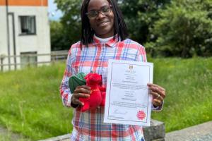 Image of International Student Mentor - Onohomen Audu (Celestine) holding a red dragon