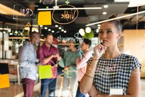 Marketing meeting reviewing content on a computer screen