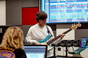 Musician recording the bass guitar in studio