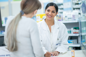 Pharmacist talking to a customer over a counter