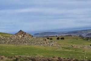 A ruined cottage in a mountain landscape