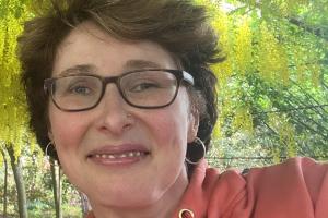 Photograph of Dr Mari Elin Wiliam in the laburnum arch at Bodnant Gardens.