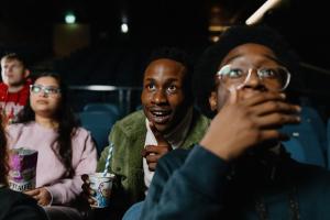 A group of students sitting down in the cinema in Pontio and watching a film