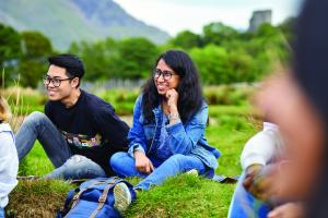 A group of students socialising in a scenic area