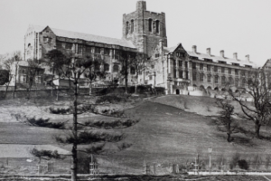 Black and white photograph of Bangor University Main Arts Building at the top of a hill