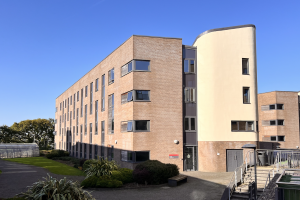 Cemlyn building with blue sky