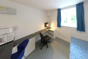 St Mary's Studio with a bed, desk, chair and kitchenette